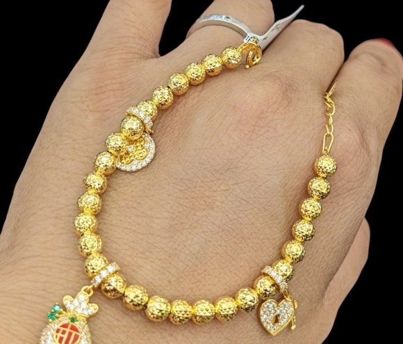 Lắc Tay Bi TT Túi Tiền Charm Hột Trắng